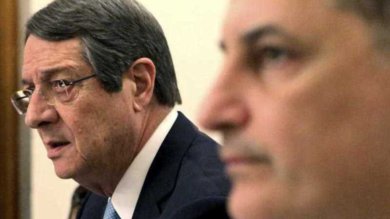 Cyprus' energy minister Yiorgos Lakkotrypis, right, and Cyprus' President Nicos Anastasiades