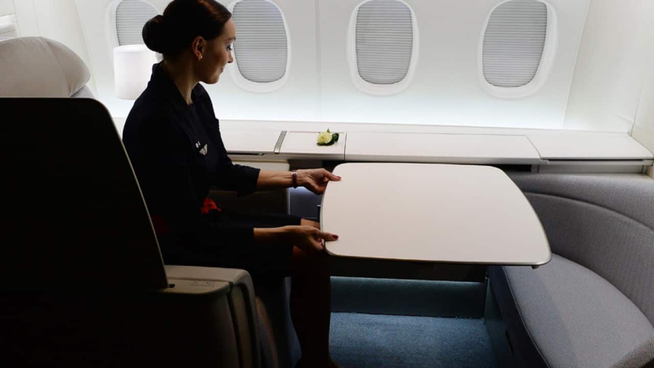 An Air France attendant shows off the airline's haute couture suite
