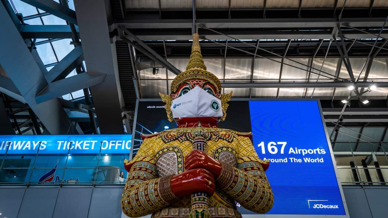 Masked Ramayana statue is pictured at the departures hall at Suvarnabhumi Airport.Travelers pass through an empty Suvarnabhumi Airport in Bangkok, Thailand, on January 12, 2022. The Test and Go program, which allows fully vaccinated tourists to enter the
