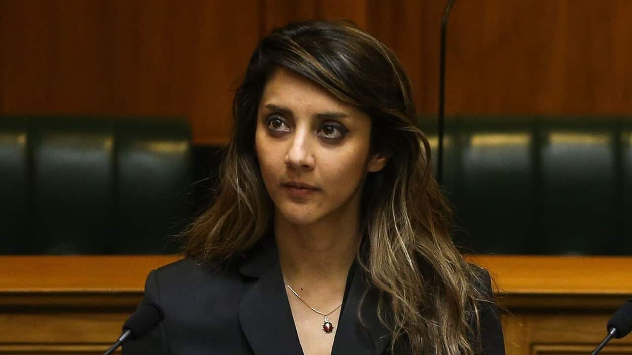 A young woman wearing a suit