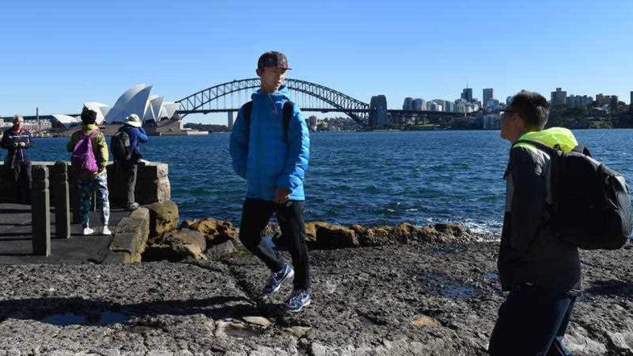 Chinese tourists take in the sites of Sydney.