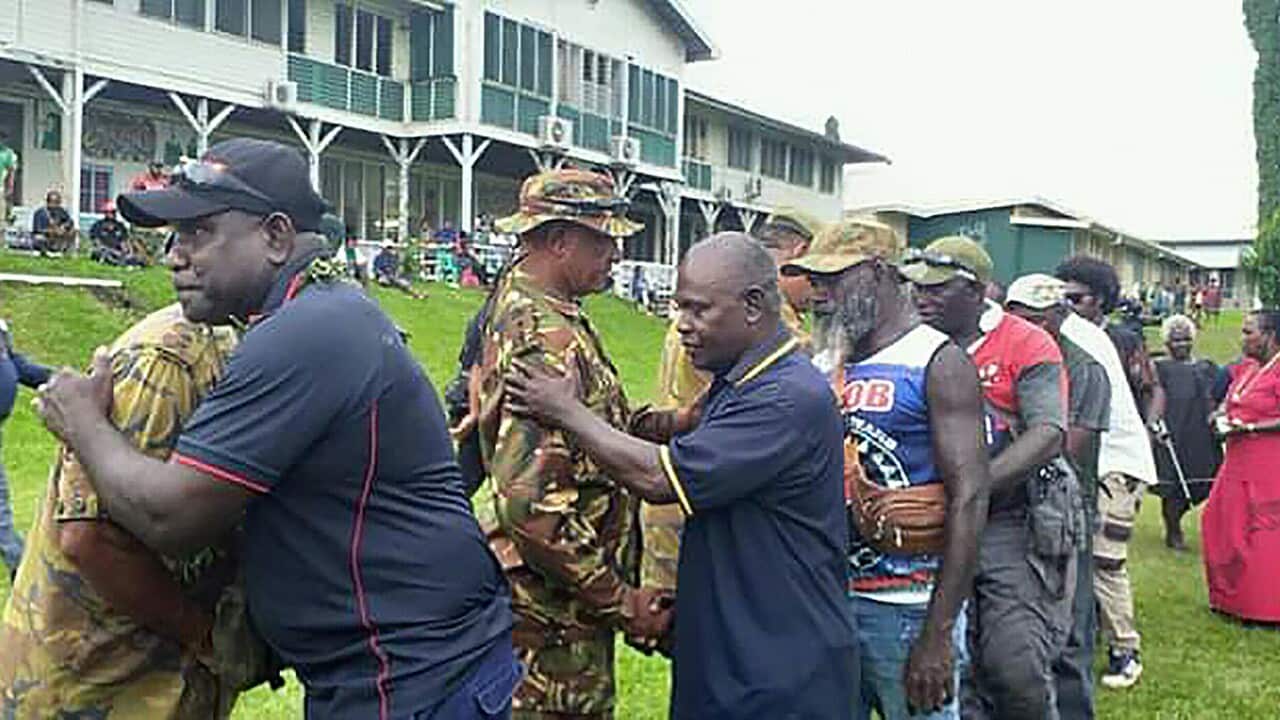 Bougainville Revolutionary Army fighters hugging PNG policemen at a Bougainville reconciliation ceremony ahead of eferendum in Kokopo, taken on Nov 6,2019.