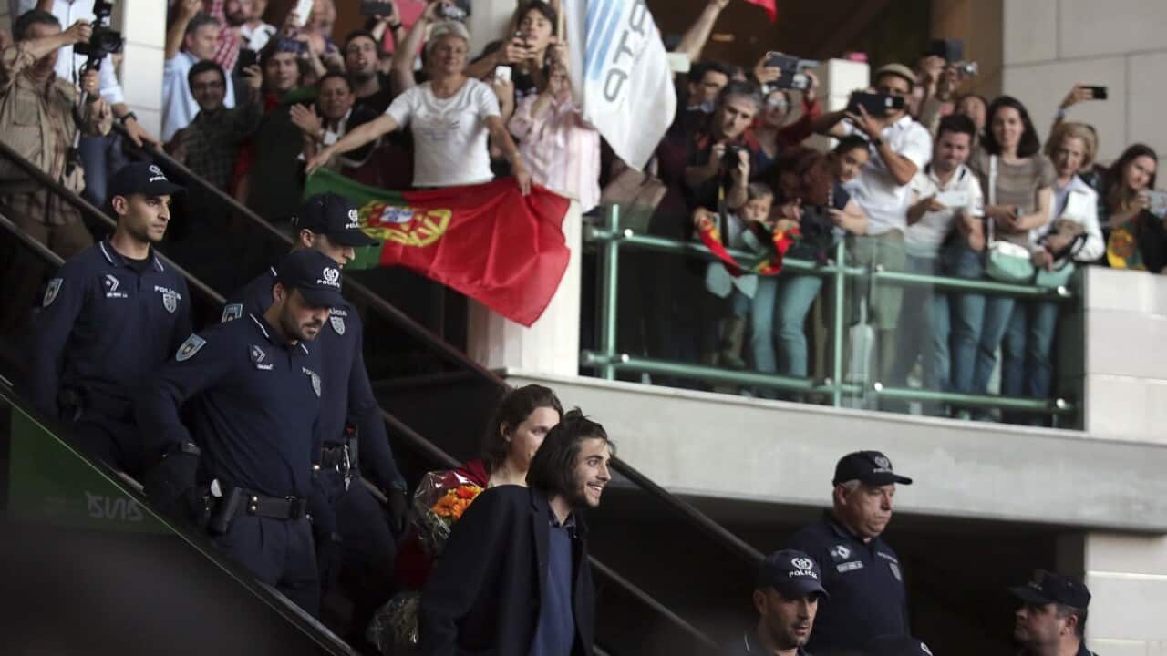 Salvador Sobral, center, smiles at cheering fans at Lisbon airport on 14 May.