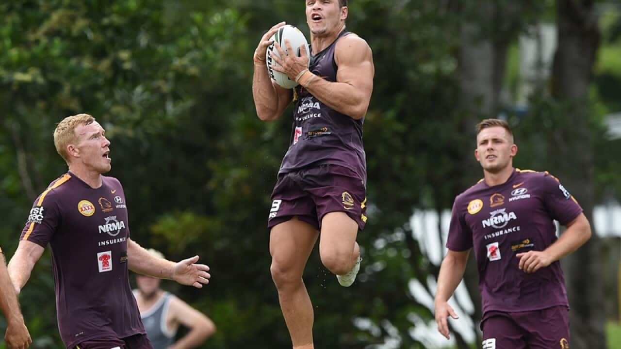James Roberts (centre) receives the ball