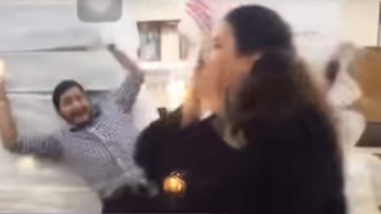 Screen grab from the ad, showing a man falling into a  tower of sheets