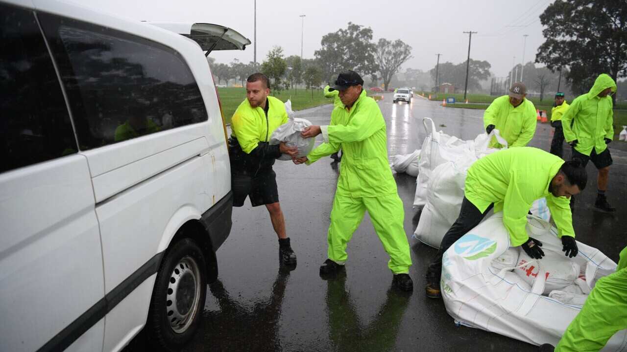 Penrith City Council workers load sand bags into residents cars at Jamison Park in Sydney, Wednesday, March 2nd, 2022. A developing east coast low is beginning to impact Sydney with heavy rain that could cause flash flooding and potentially hazardous cond