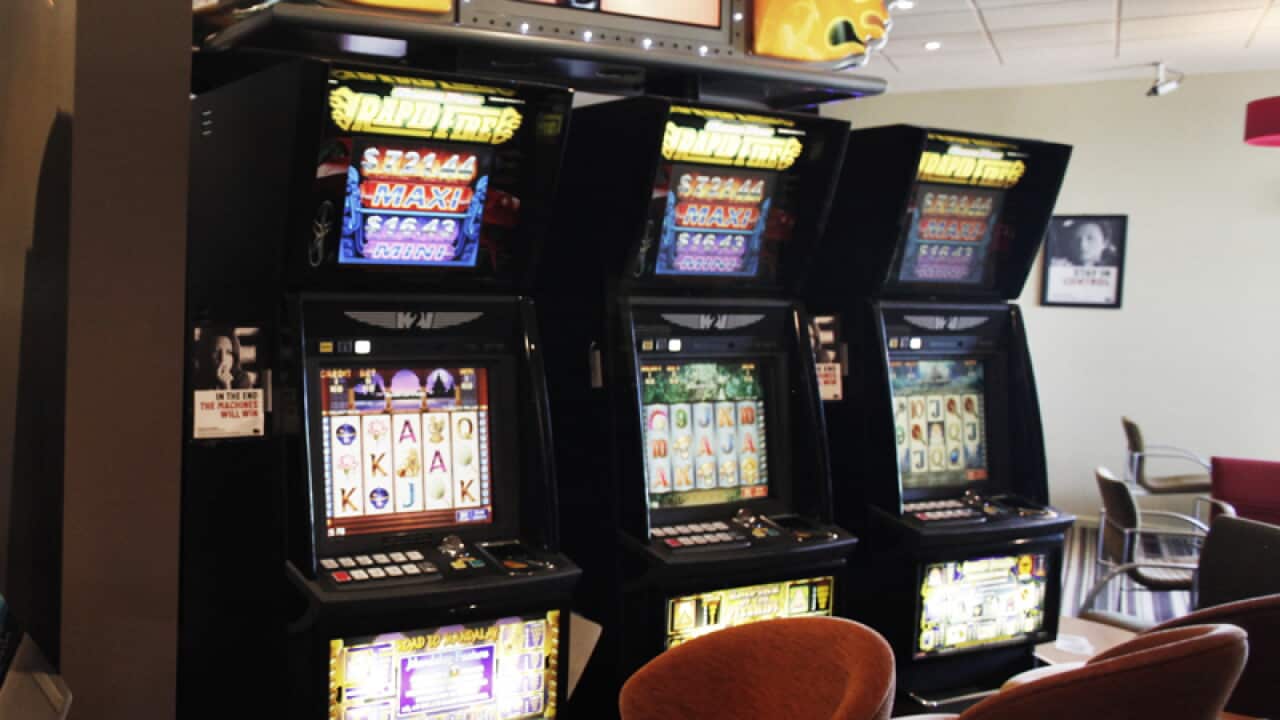 A man plays a pokie machine