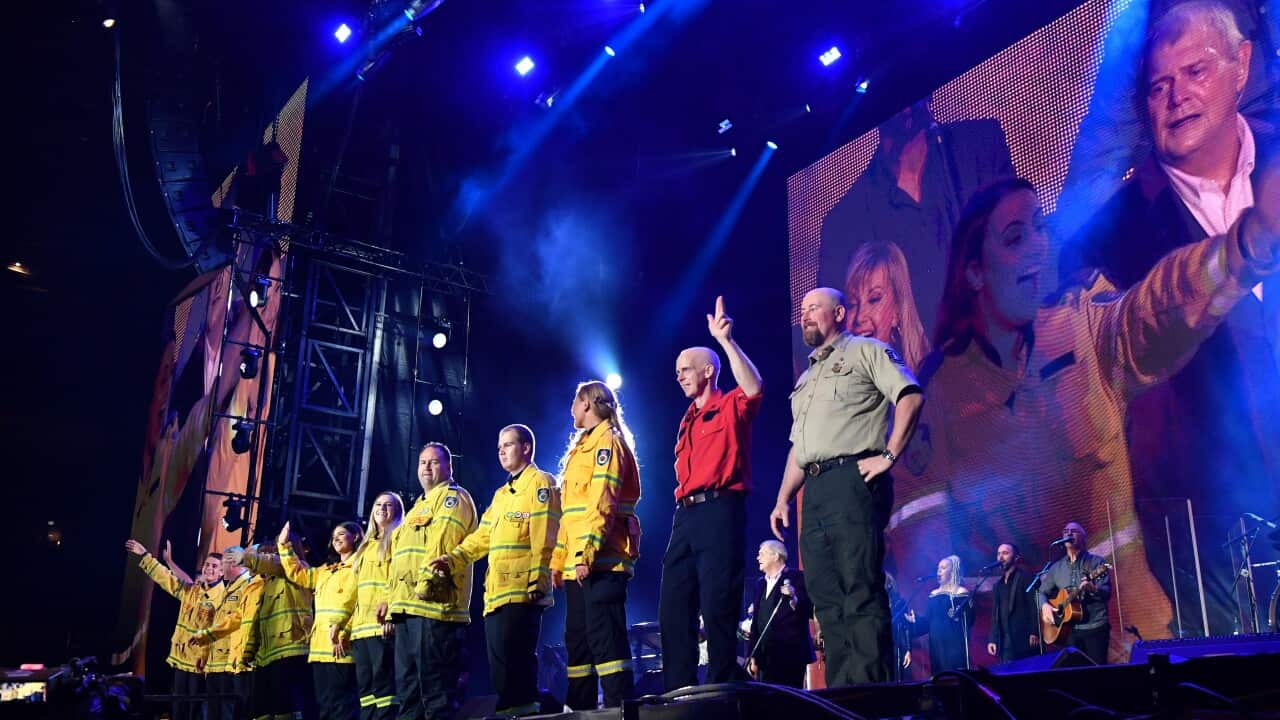 Firefighters join John Farnham and Olivia Newton-John on stage as they perform during the Fire Fight Australia bushfire relief concert at ANZ Stadium in Sydney.