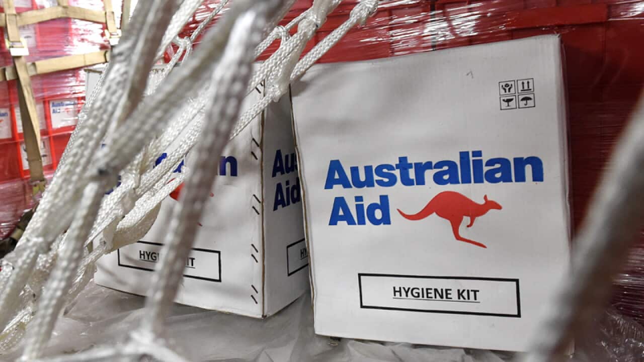 Aid is seen onboard an Australian RAAF aircraft in Brisbane