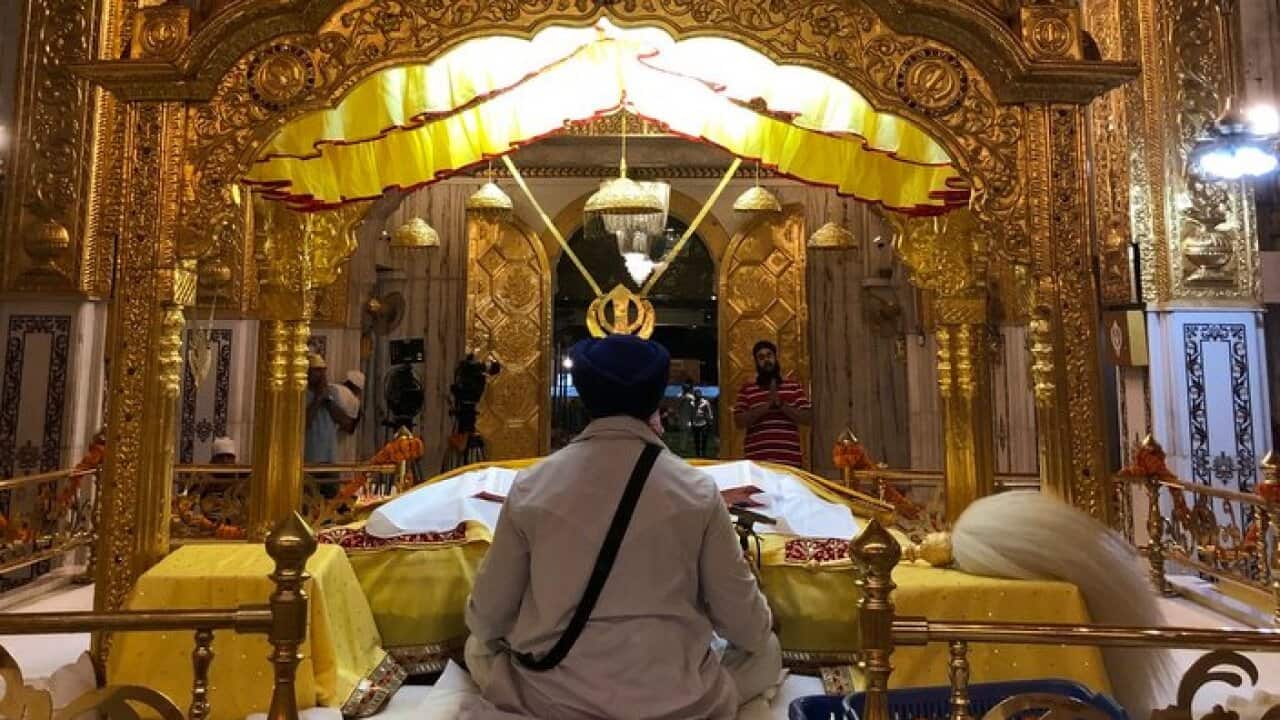 Guru Granth Sahib, the Sikh holy scriptures being read inside a Gurudwara