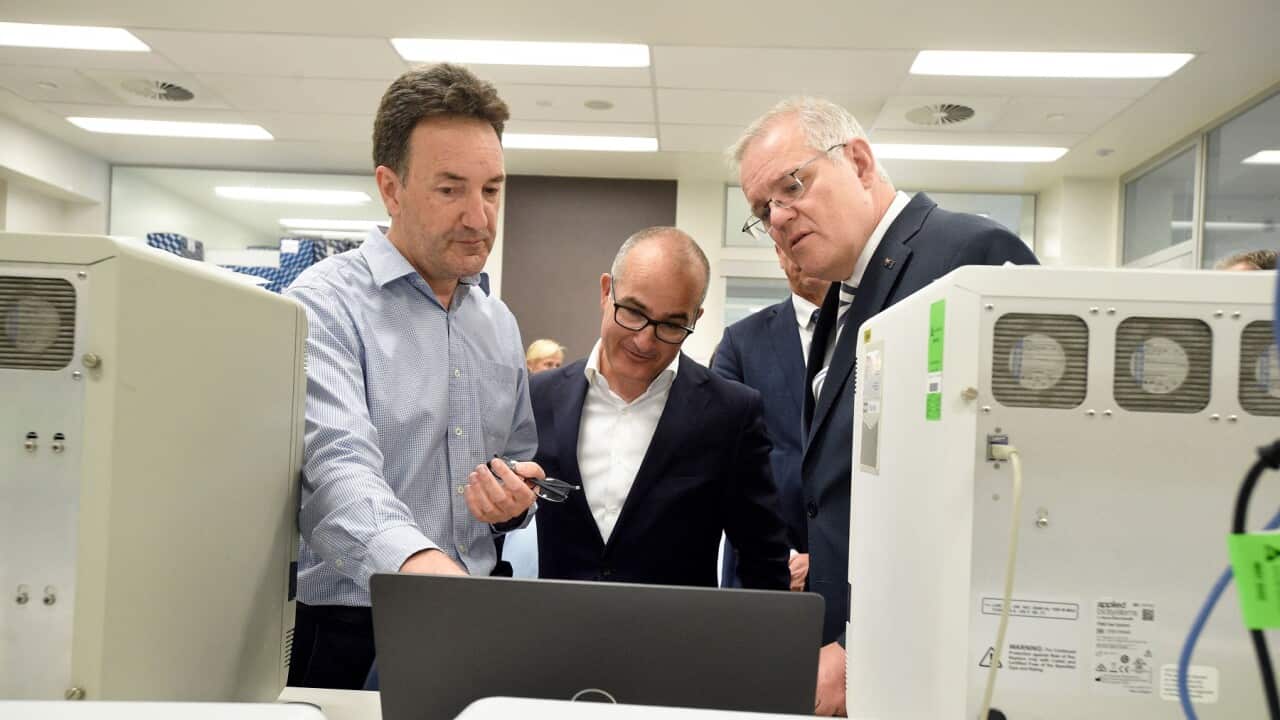 Prime Minister Scott Morrison (R) and Victorian Deputy Premier James Merlino (C) at the Peter Doherty Institute in Melbourne with Dr Julian Druce