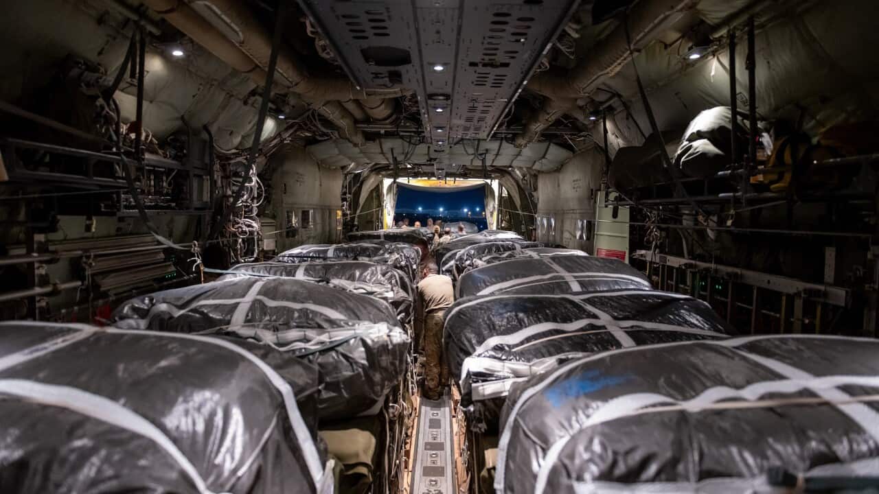 Humanitarian aid pallets rigged with parachutes for airdrop aboard a C-130J Super Hercules (AAP)