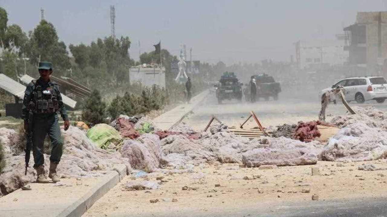Afghan security officials inspects the scene of a bomb explosion in Kandahar, Afghanistan, 22 May 2018.