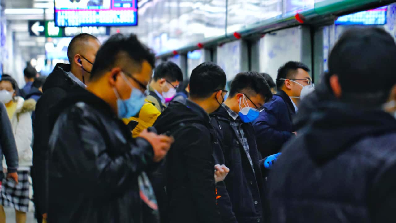 A crowd of people at a Beijing train station on 17 March 2020.
