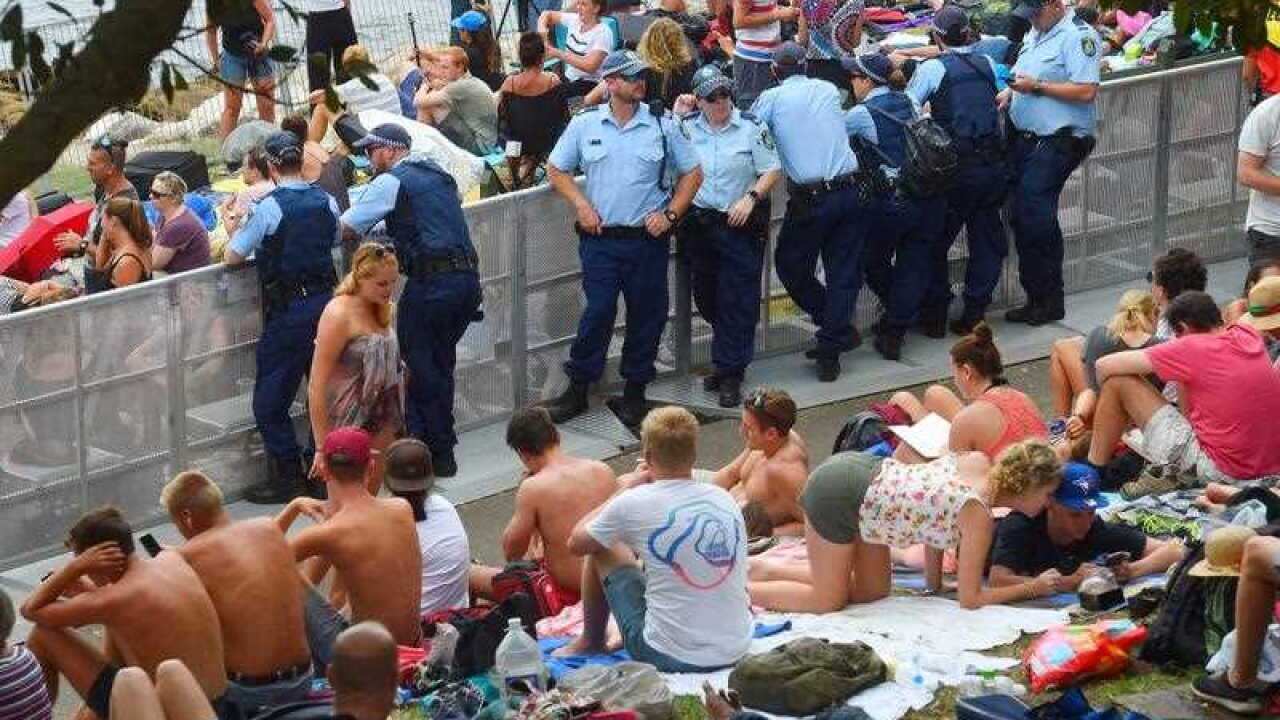 Police patrol through the crowds at Mrs Macquarie's Chair on the foreshore of Sydney Harbour
