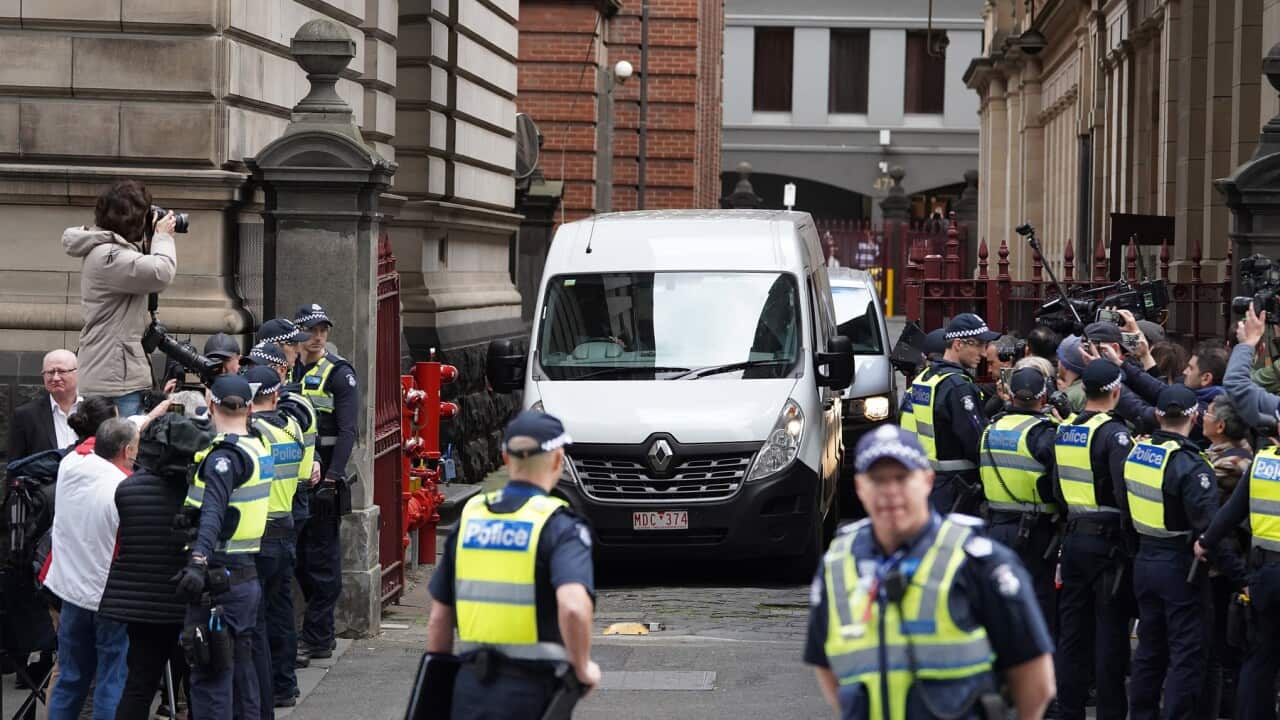 Police and media outside the Supreme Court as Pell is led away to prison in a Corrections van.