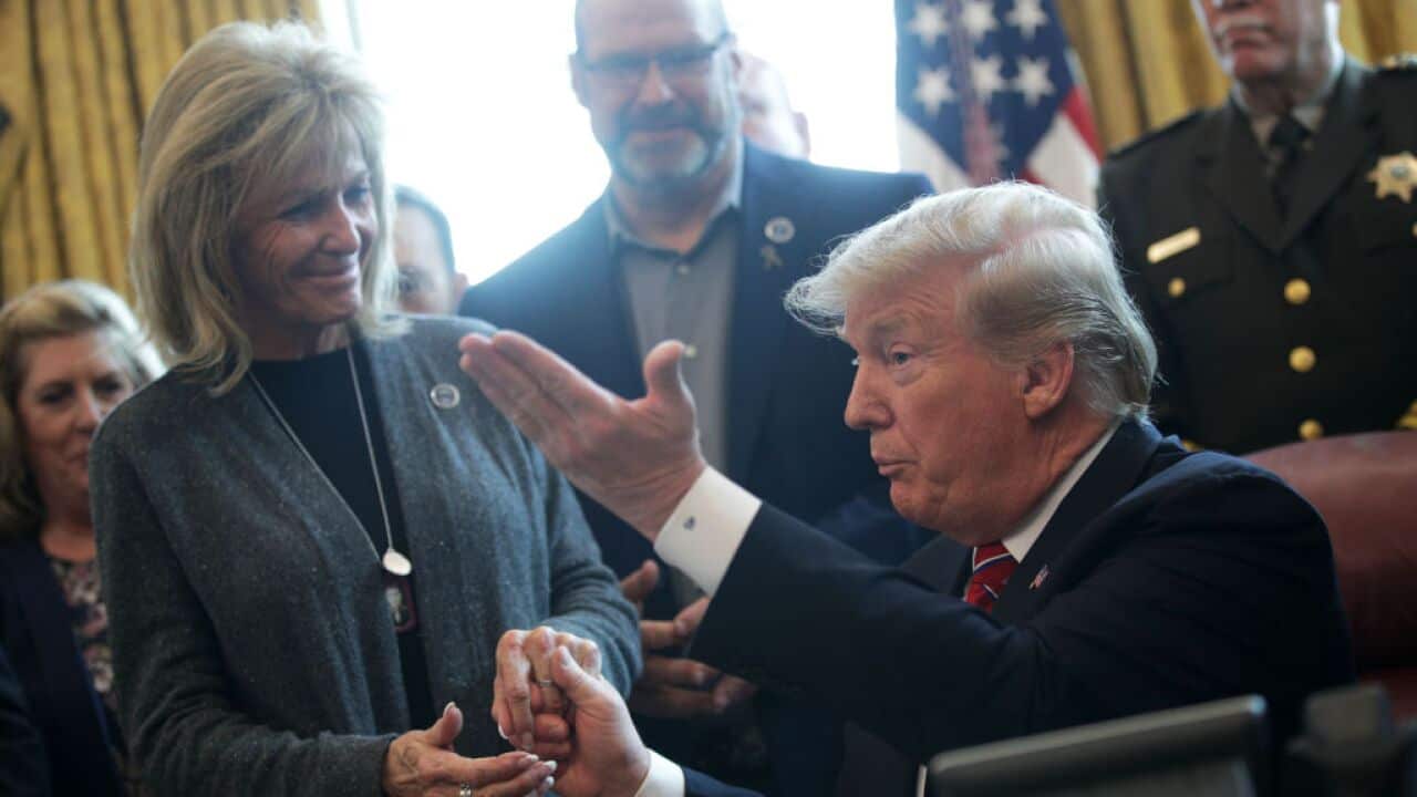 Donald Trump (R) greets Mary Ann Mendoza (L) during an event at the White House, March 15, 2019 in Washington, DC.