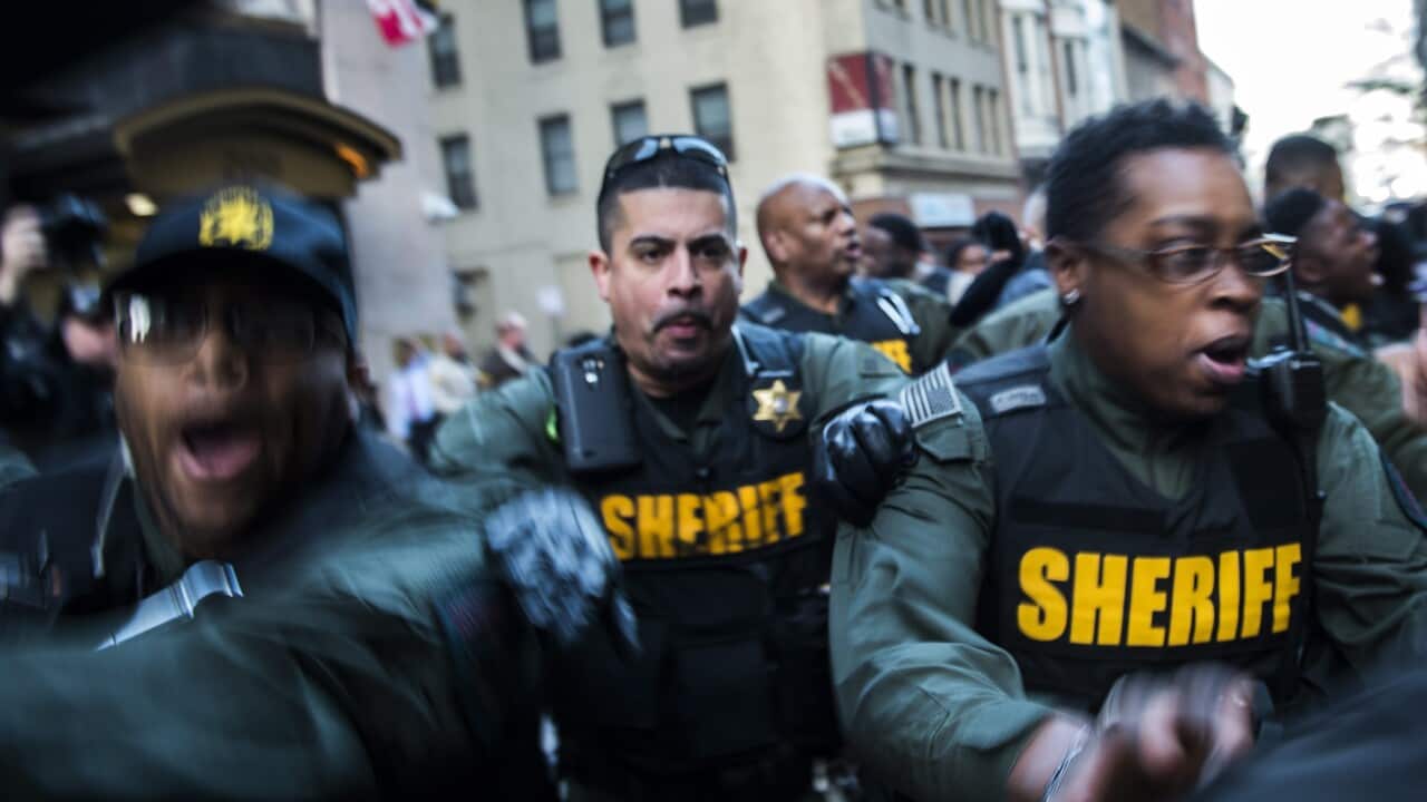 Baltimore City Sheriffs push through a crowd of protesters and reporters at the Baltimore City Circuit Court House East after the jury deadlocked in the trial of Baltimore Police Officer William G. Porter in Baltimore, Maryland, USA, 16 December 2015.