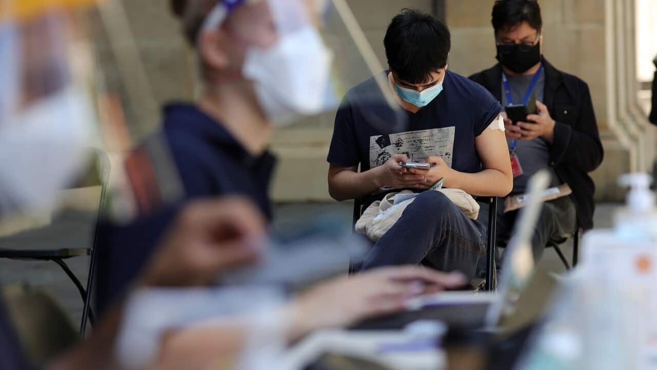 People are seen at a Cohealth pop-up vaccination clinic at the State Library Victoria, in Melbourne, Monday, 20 December, 2021.