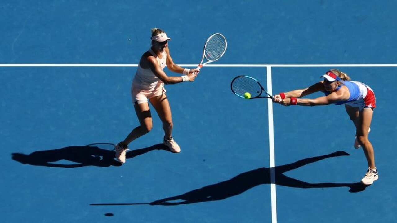 Elena Vesnina (L) of Russia and Ekaterina Makarova of Russia talk tactics in their women's doubles match against Yifan Xu of China and Gabriela Dabrowski of Canada on day nine of the 2018 Australian Open at Melbourne Park on January 23, 2018 in Melbourne,