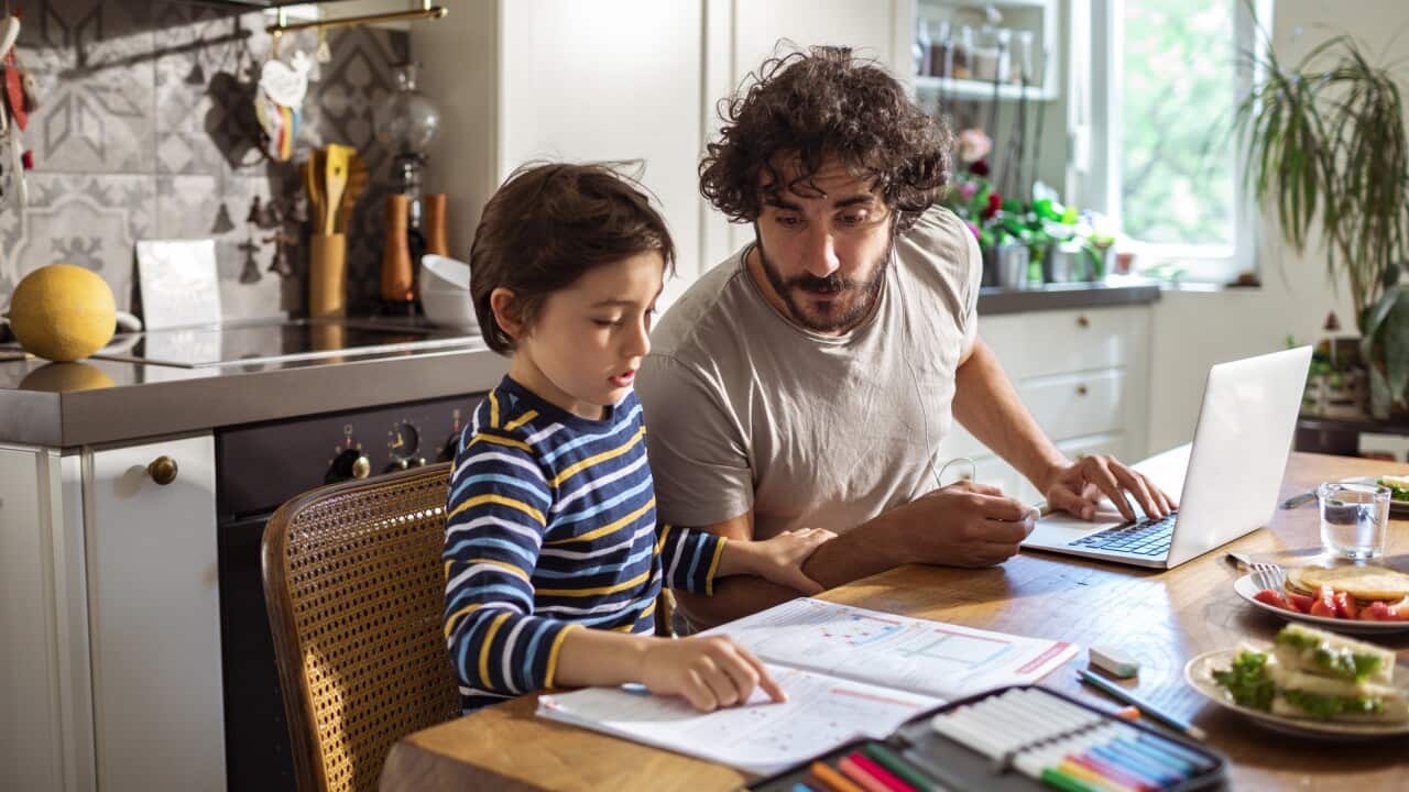 Father helping his son with schoolwork