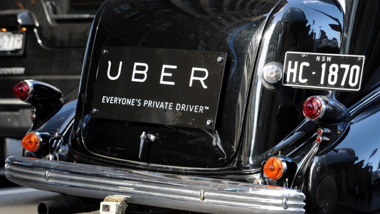 An Uber sign on the back of a vintage car