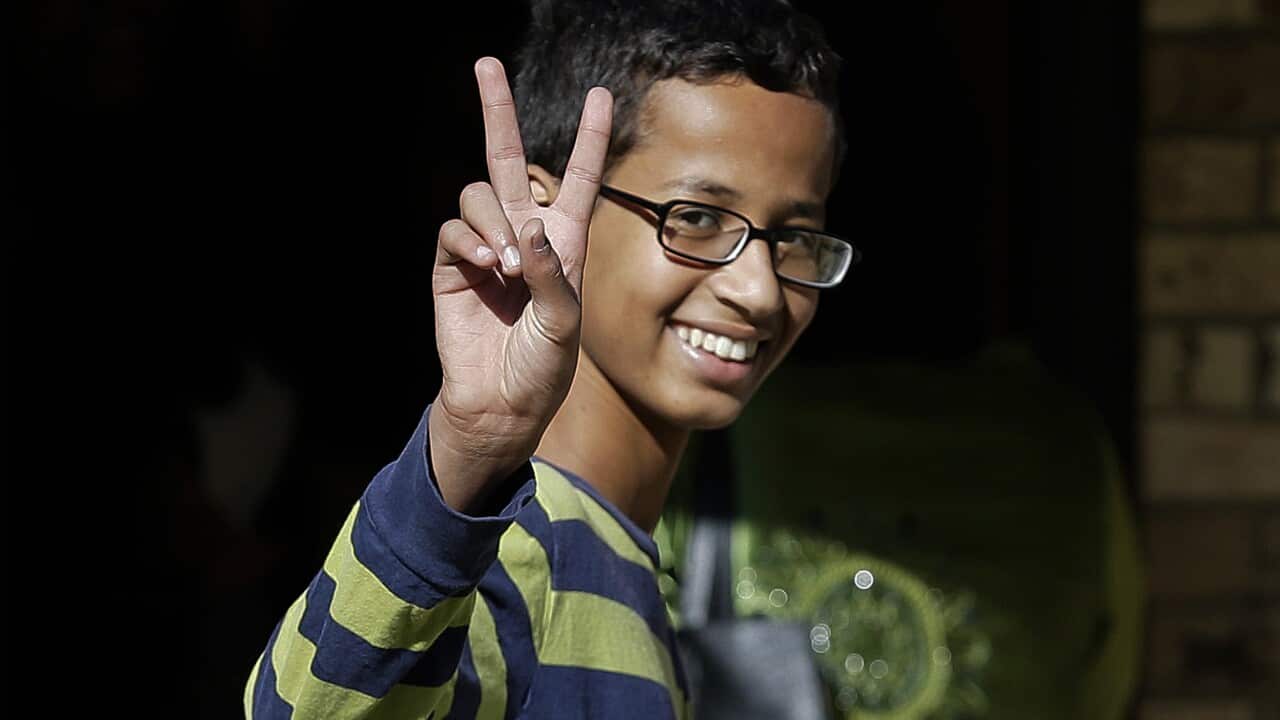Ahmed Mohamed gestures as he arrives to his family's home in Irving, Texas. The 14-year-old Muslim boy got in trouble over a homemade clock mistaken for a possible bomb has withdrawn the boy from Dallas high school (AP Photo/LM Otero, File)