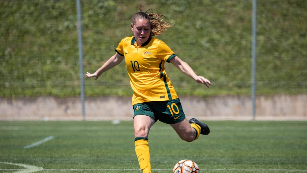 Woman kicking football