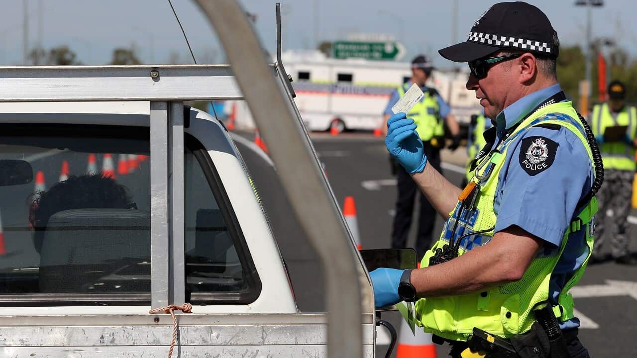 Police officers stop drivers in WA.