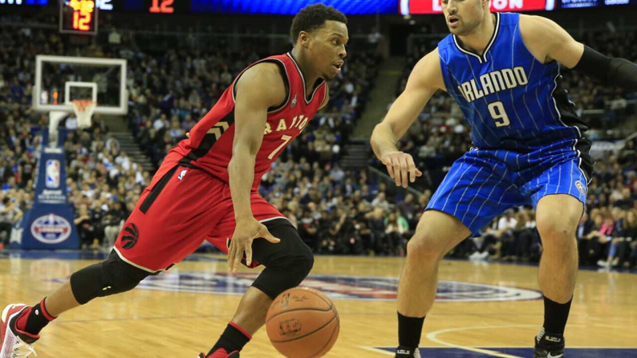 Toronto's Kyle Lowry, left, Orlando Magic's Nikola Vucevic
