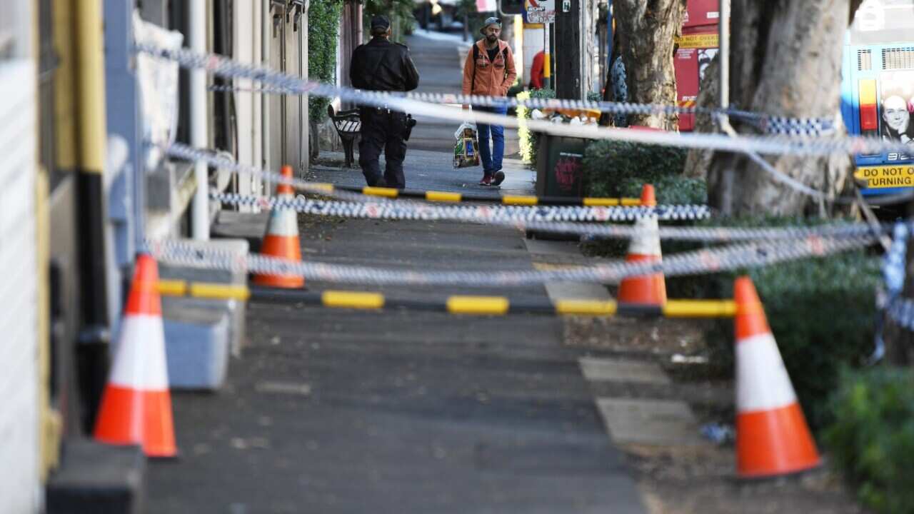 Police tape blocks of a section of pavement outside the front of of a property in Surrey Hills in Sydney after counter-terrorism raids