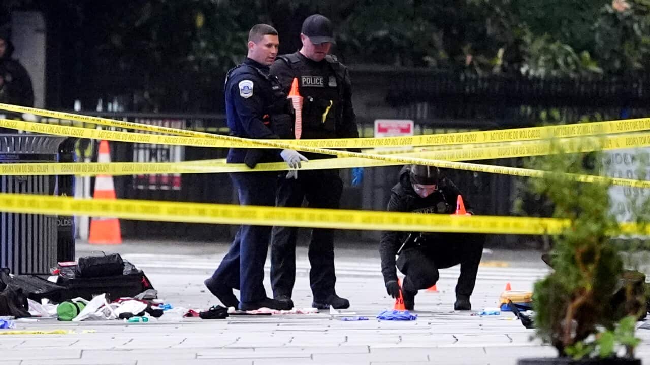 Police inspect a crime scene on the streets of Washington DC