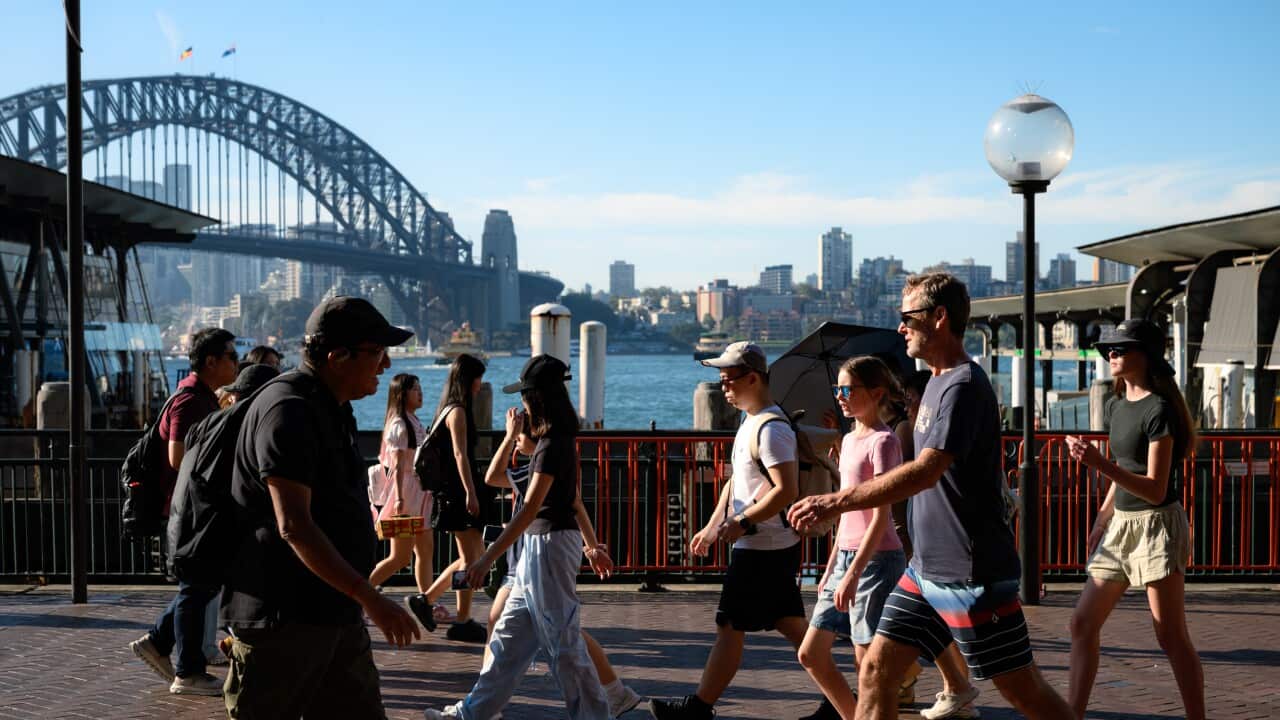 People walk by the harbour