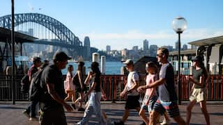 People walk by the harbour