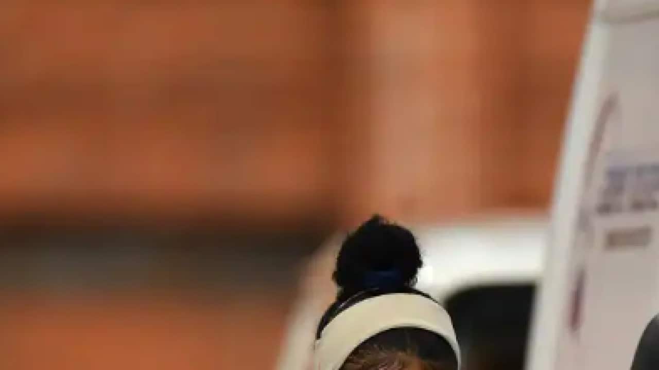 A healthcare worker is seen preparing to take a sample for a COVID-19 test at a testing centre in Melbourne.