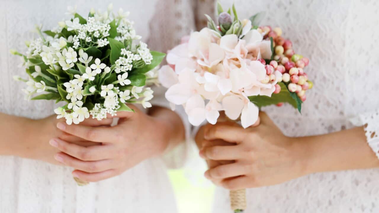 Asian girls holding wedding bouquet
