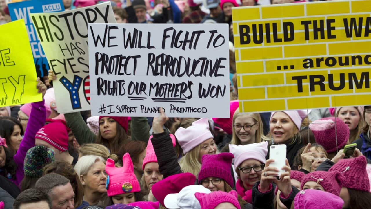 Women with bright pink hats