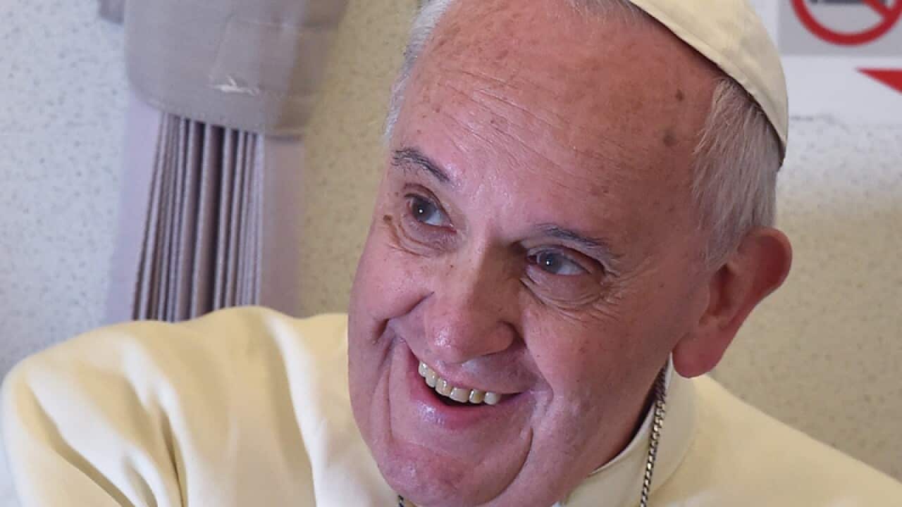 Pope Francis as he talks with journalists.