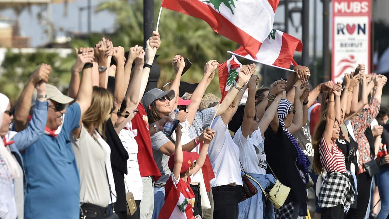 Lebanese protesters form a human chain along the coast from north to south as a symbol of unity, during an anti-government protests.