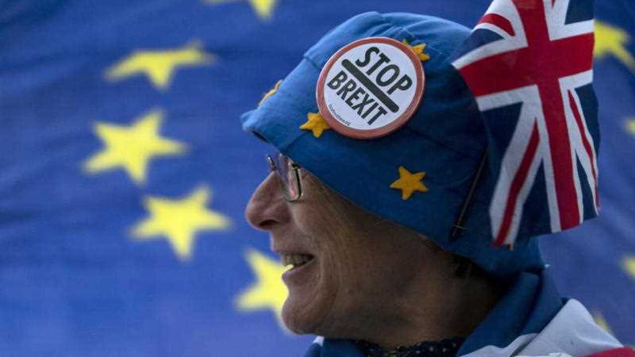 An anti Brexit protester stands outside the Houses of Parliament in London.