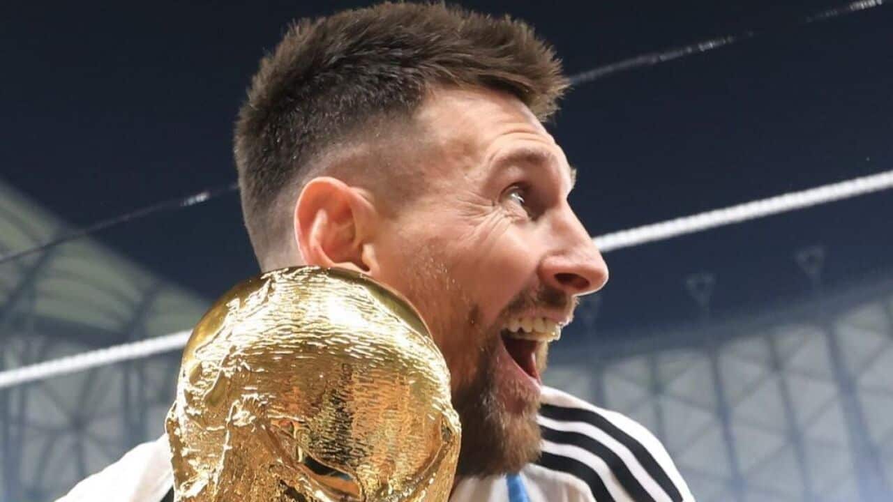 Lionel Messi from Argentina holds FIFA World Cup 2022 gold trophy.