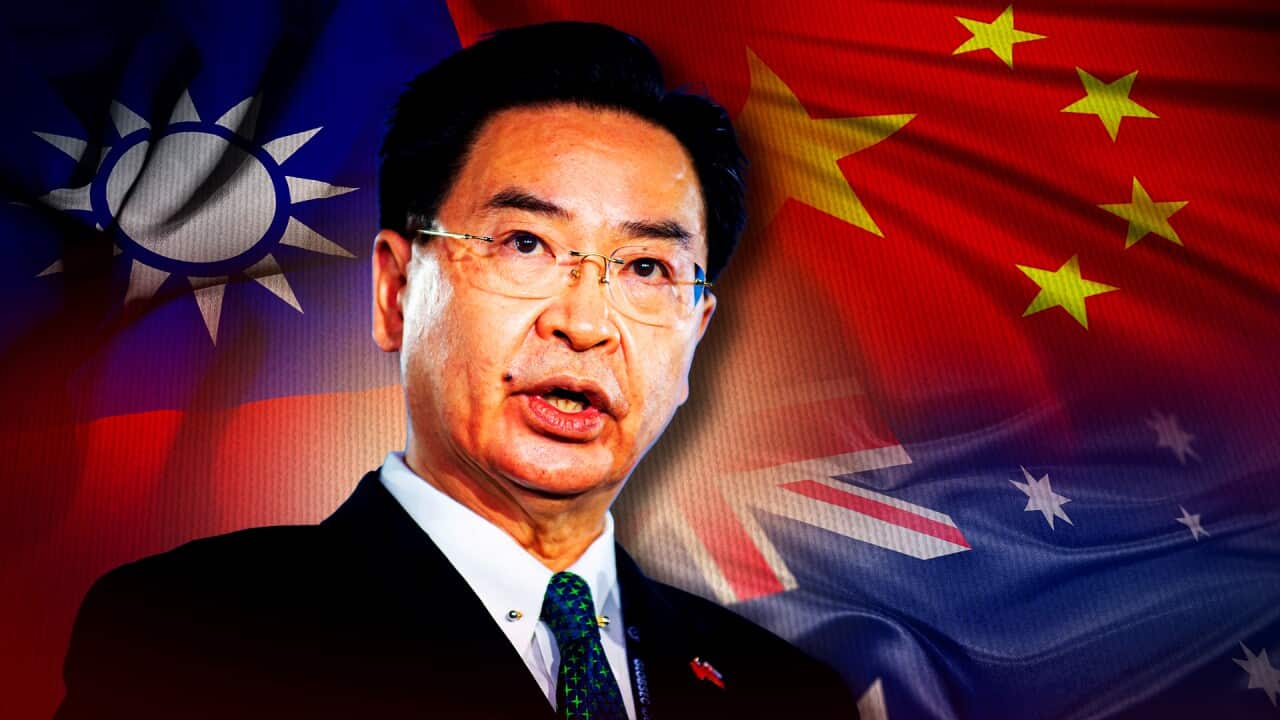 Taiwan Foreign Minister Joseph Wu in front of Taiwan, China and Australian flags.