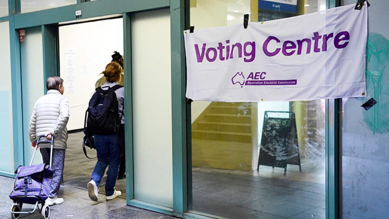 Voters are seen entering a pre-polling booth at Central Station, Sydney.