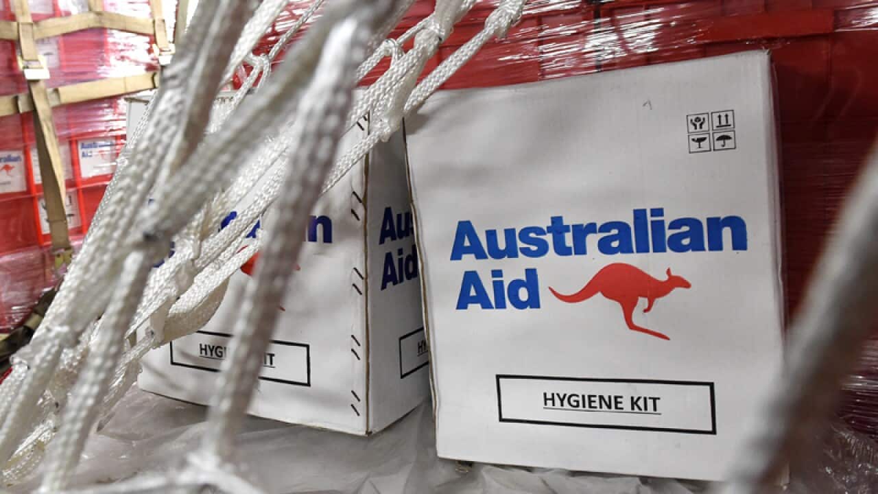 Aid is seen onboard an Australian RAAF C-17 Globemaster