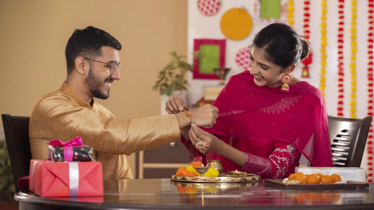 Sister tying rakhi on her brother's wrist on the occasion of Raksha Bandhan