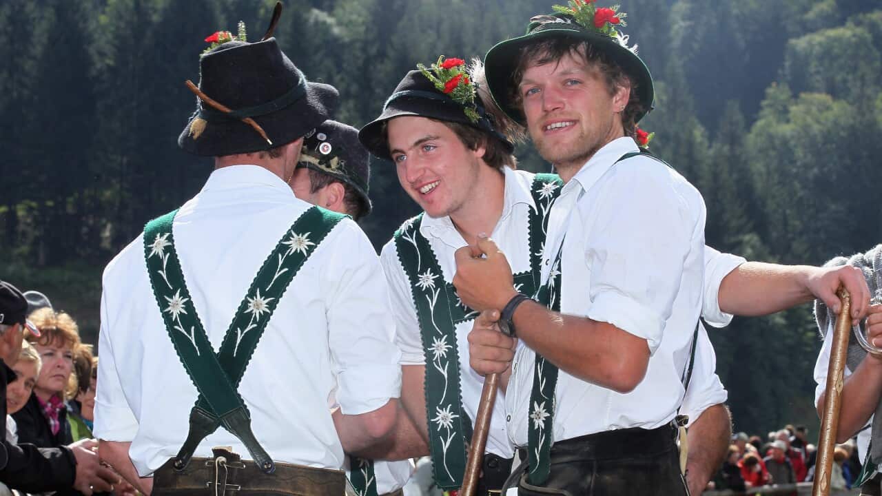 Herdsmen wearing traditional Bavarian clothes (Lederhosen) relax after the annual cattle drive descent on September 13, 2012 near Oberstdorf, Germany. (Getty)