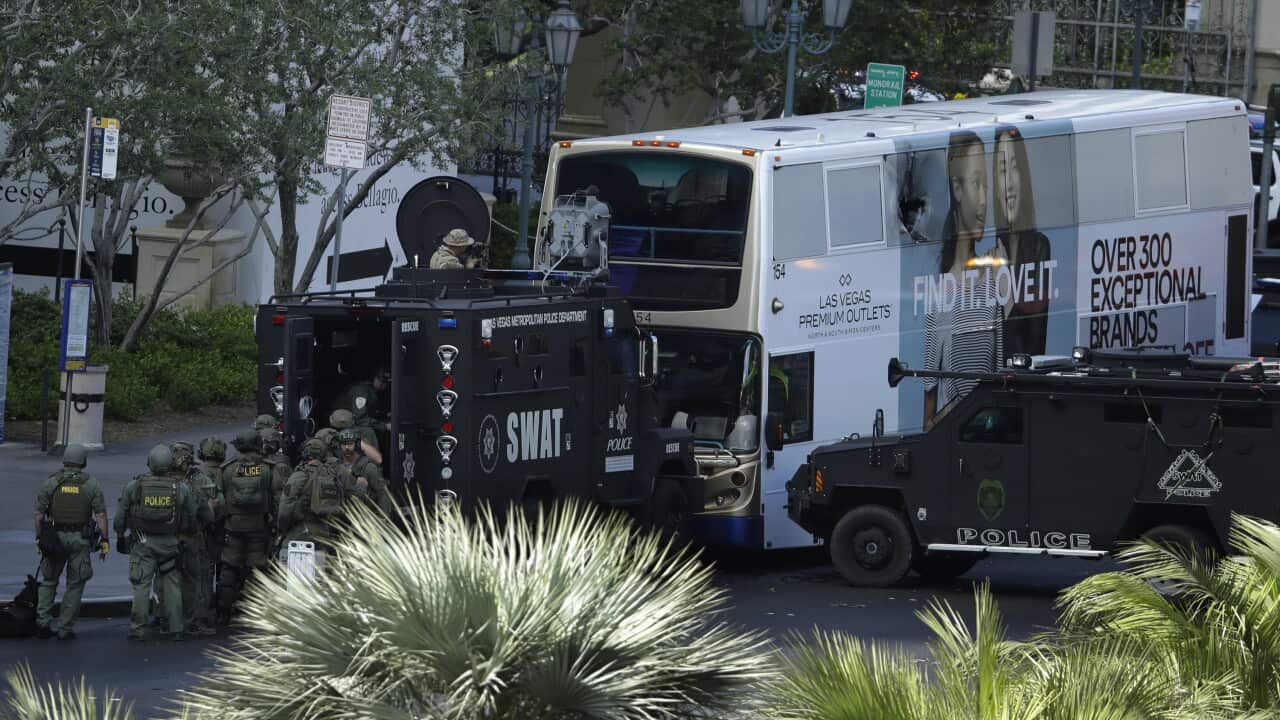 Las Vegas SWAT officers surround a bus along Las Vegas Boulevard