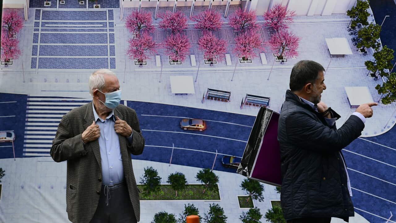 People stand at Syntagma square, Athens, Greece, Tuesday, Nov. 9, 2021.