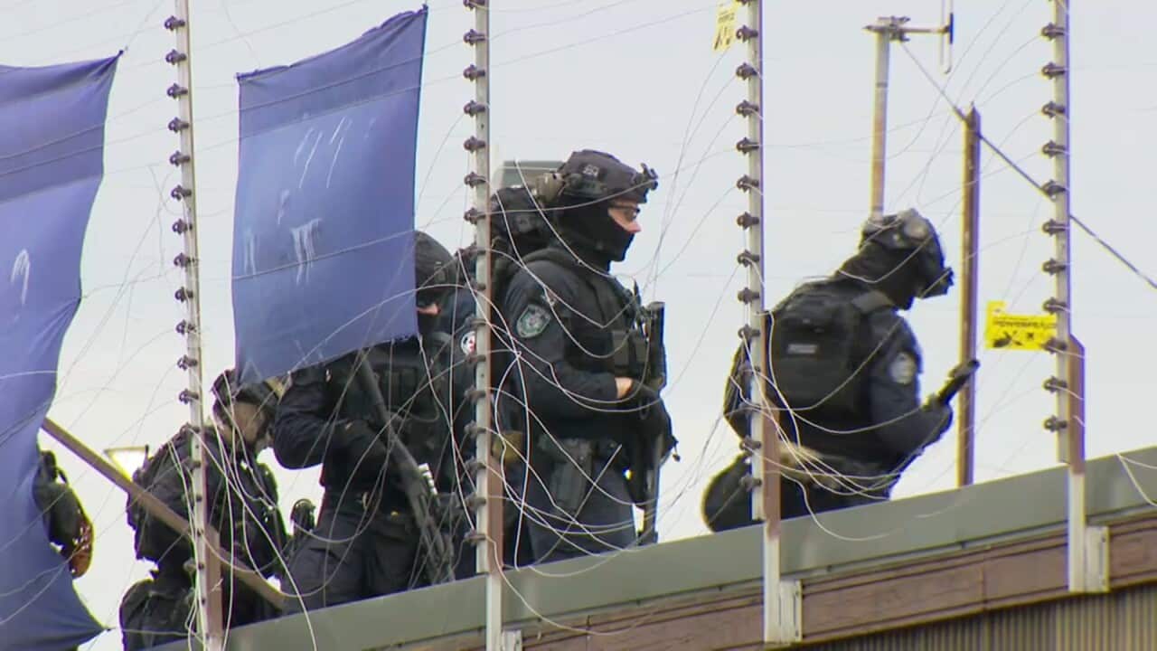 Riot police were called in to break up a rooftop protest at Villawood Immigration Detention Centre. 