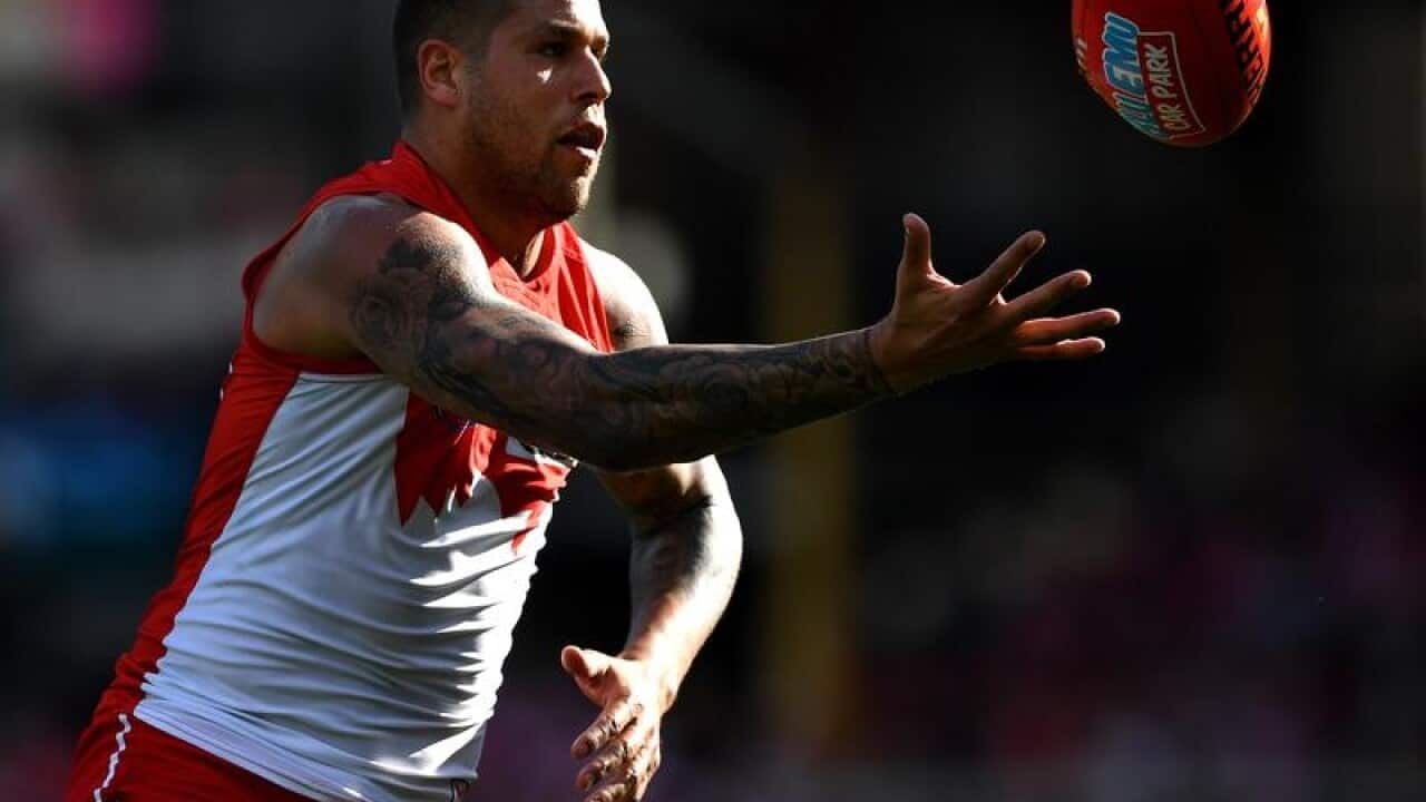 Lance Franklin of the Swans tosses the ball.